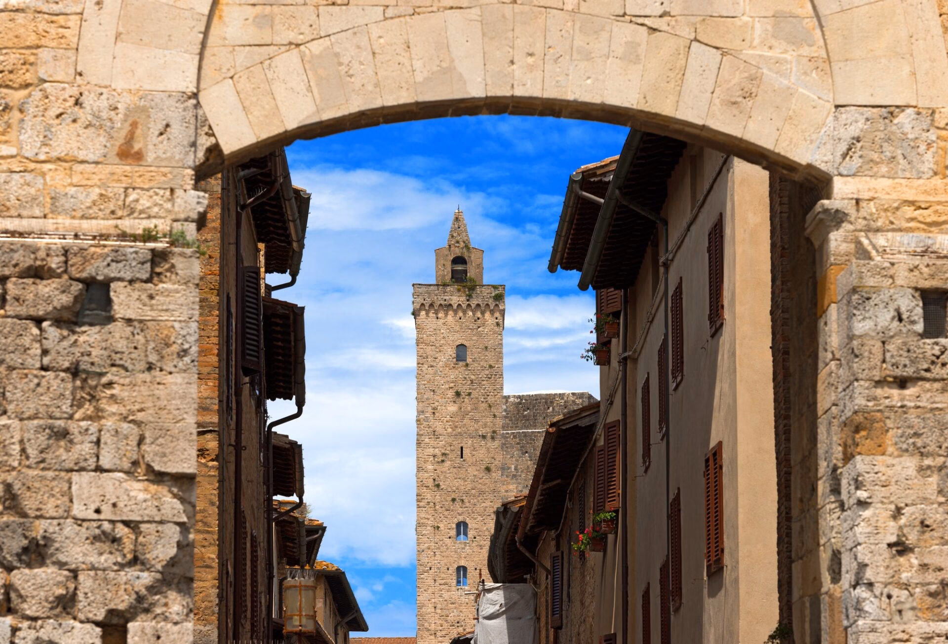 Torre Grossa in San Gimignano seen through a medieval arch