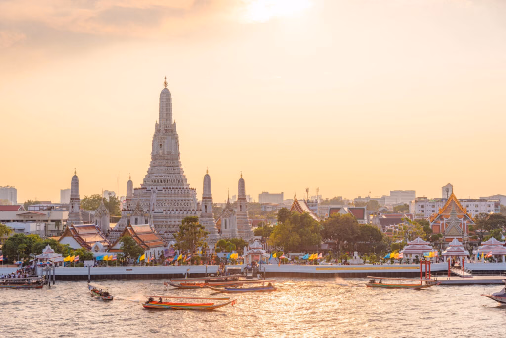 Wat Arun in Bangkok, Thailand: view from the Chao Phraya River at dusk.