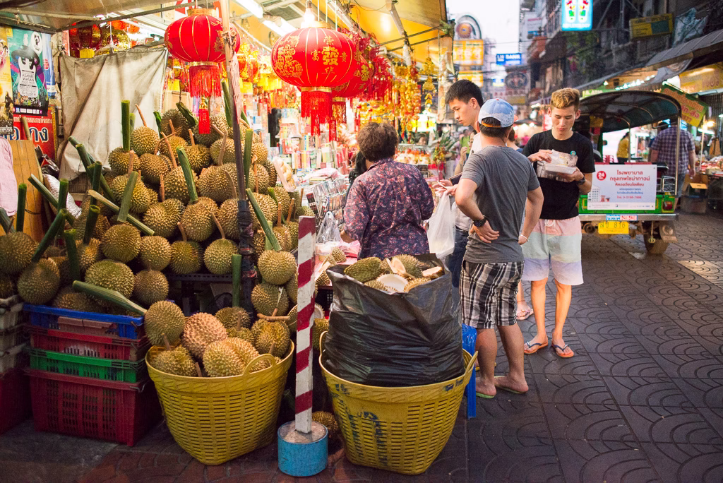 Yaowarat Road in Chinatown Bangkok at night with street food and neon signs