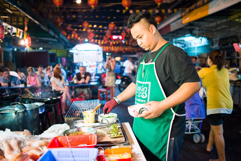 Thai street food market in Bangkok with grilled seafood