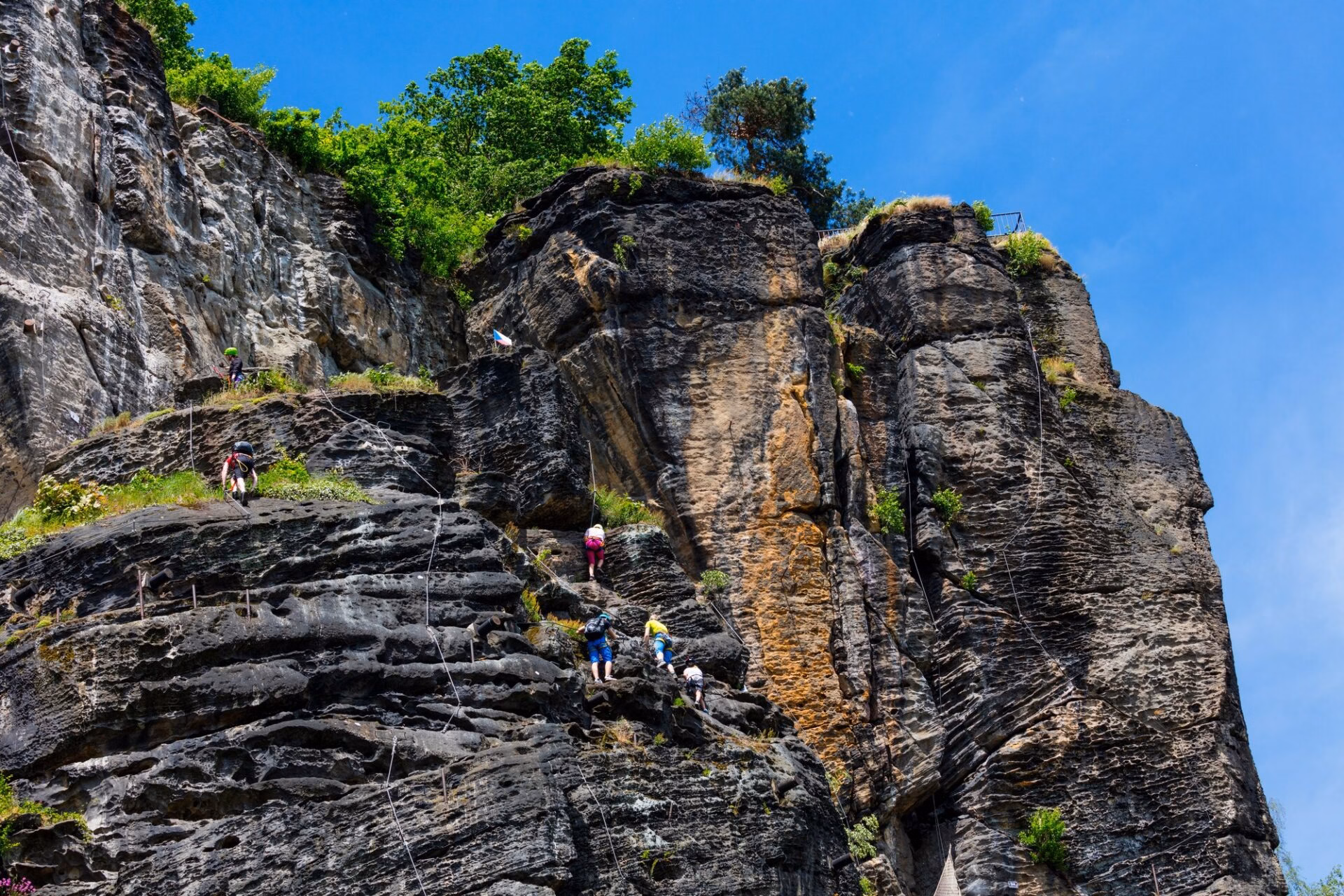 Climbers on the via ferrata on Pastýřská stěna in Děčín