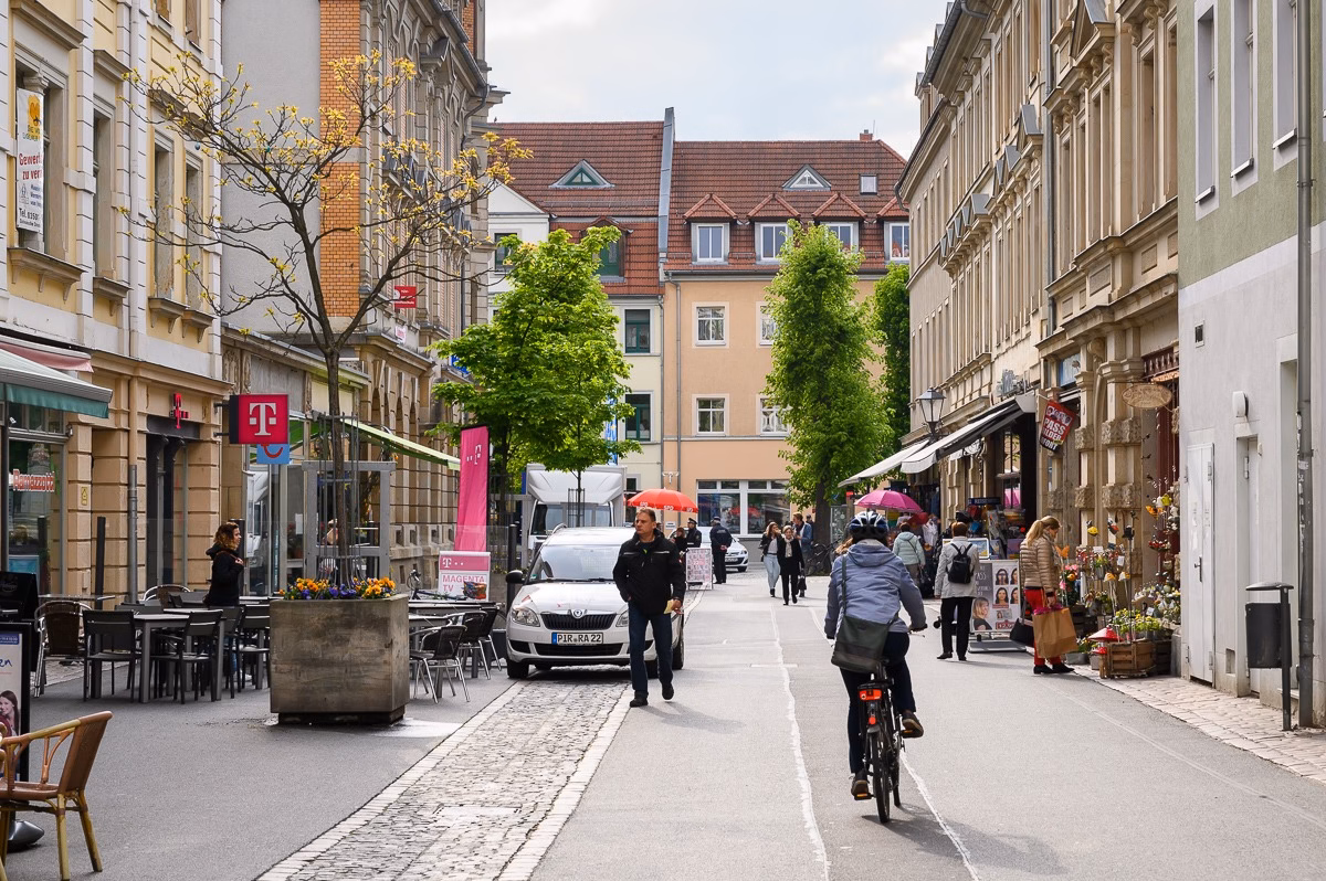 Main street in the centre of Pirna with pedestrians and cyclists