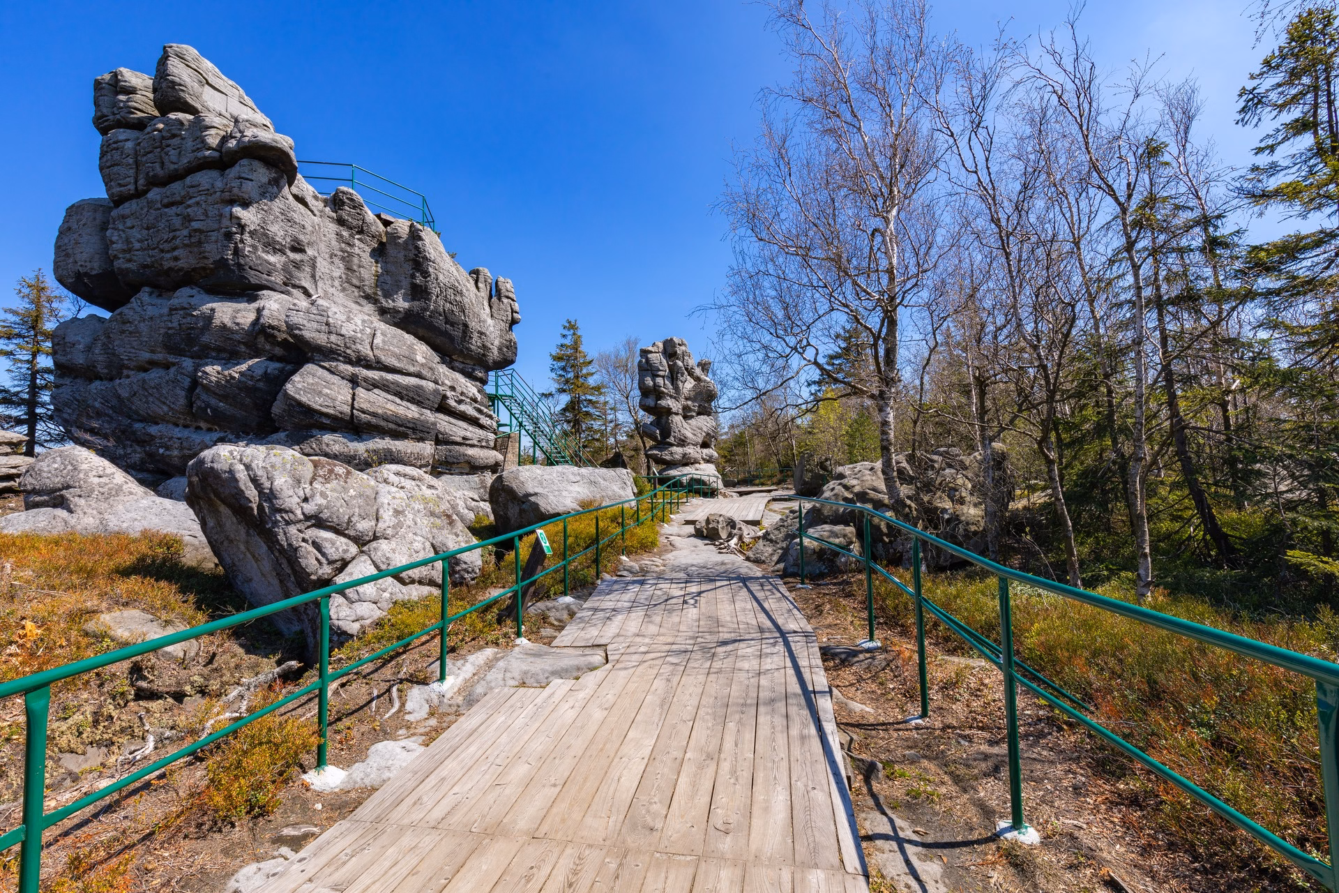 A railed viewing trail between rock formations at the summit of Szczeliniec Wielki