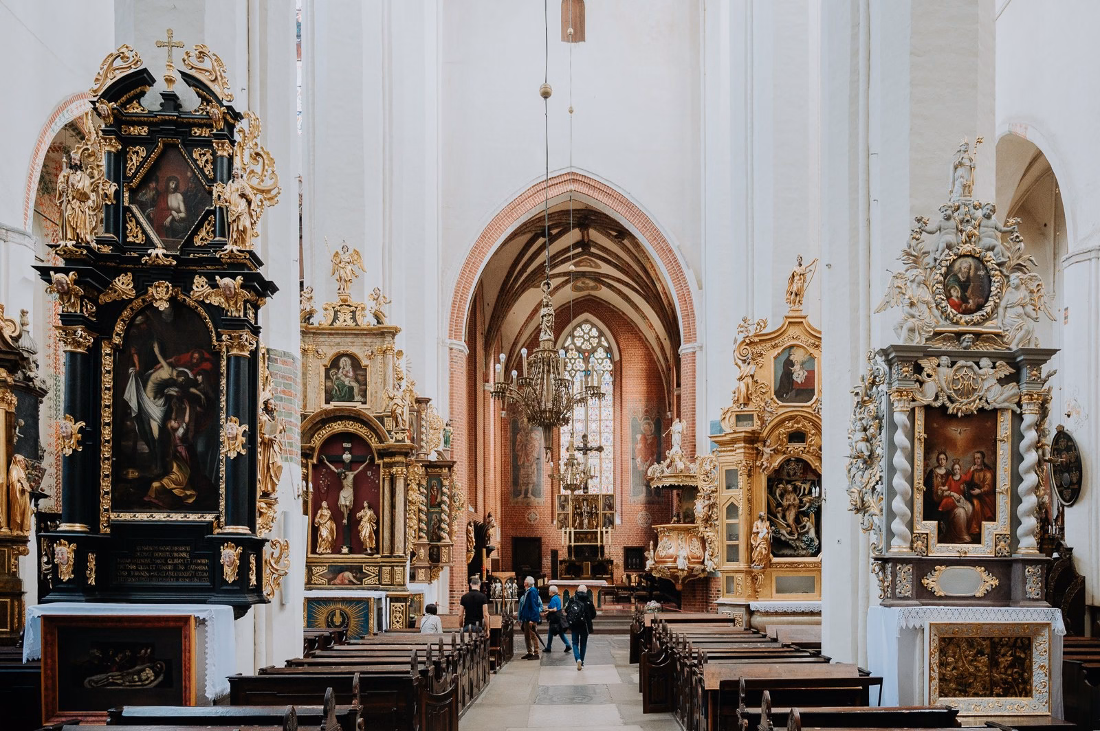 Richly decorated Baroque altar inside one of the Gothic churches in Toruń