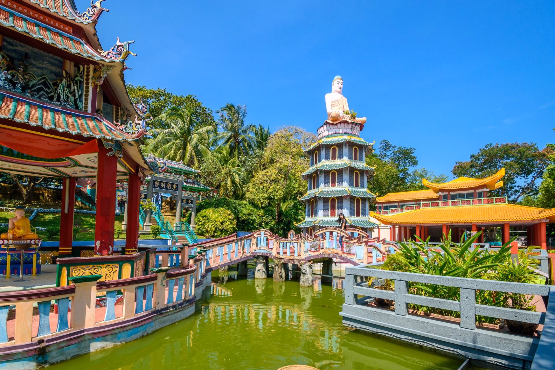 Pagoda with a Buddha statue at Haw Par Villa park in Singapore