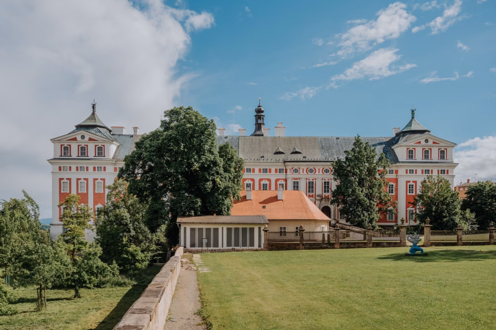 Baroque monastery of Broumov with red and white facade above the monastery garden