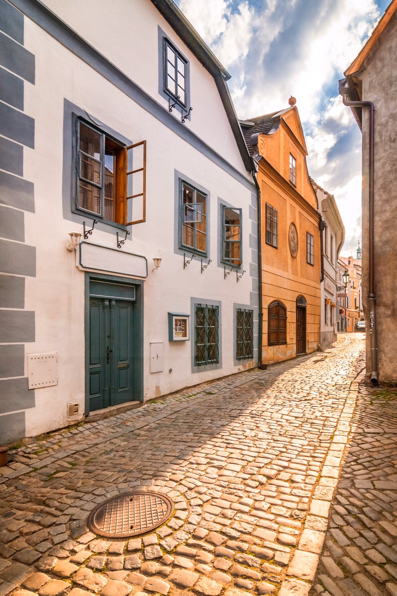 Empty cobbled street lined with burgher houses in Cesky Krumlov