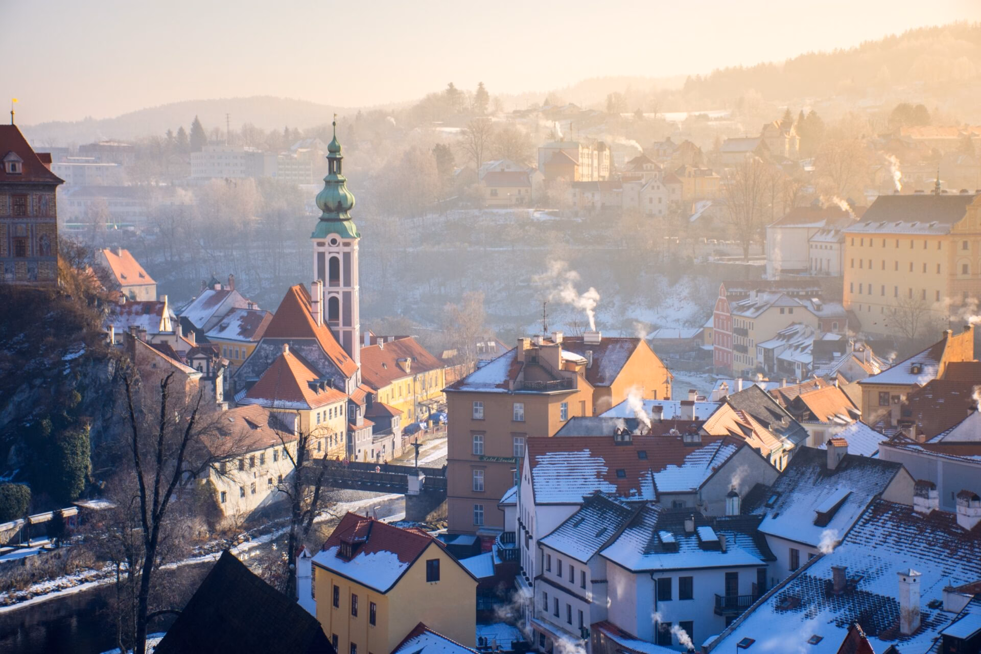 Winter morning in Cesky Krumlov with mist over snow-covered rooftops