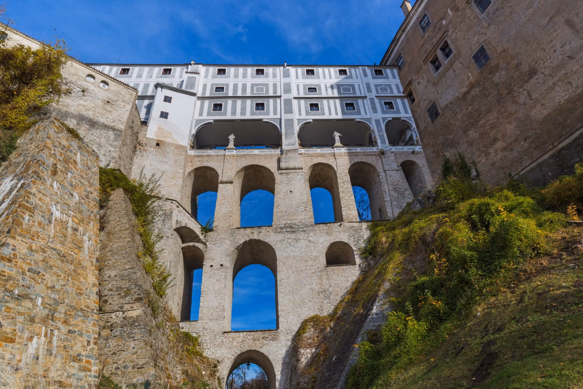The Cloak Bridge from below Arcades of the Cloak Bridge at Cesky Krumlov Castle seen from below