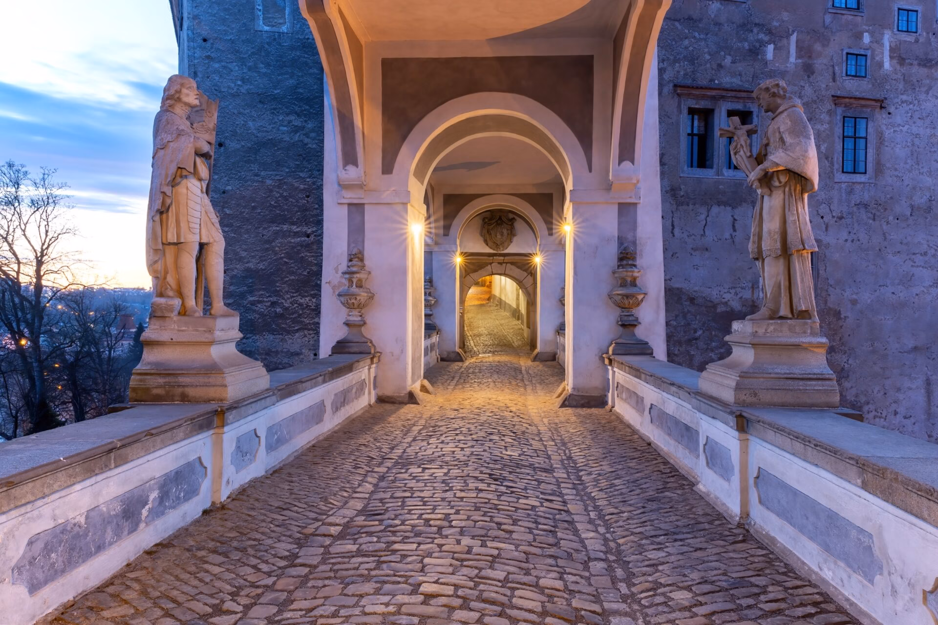 The Cloak Bridge Cloak Bridge with saint statues at Cesky Krumlov Castle at dusk