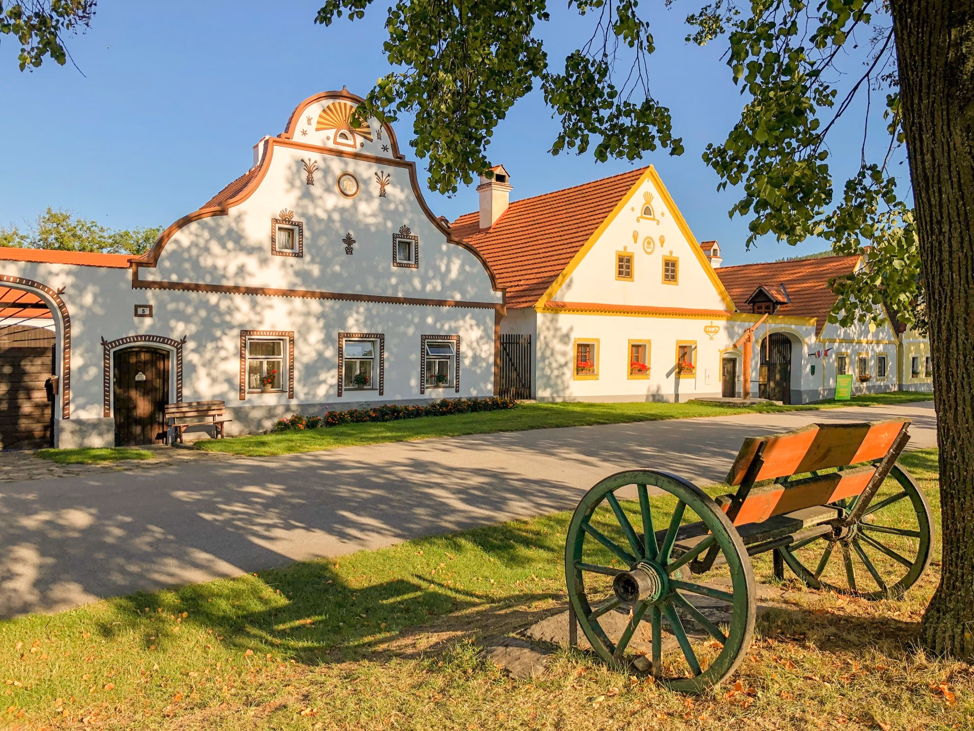 Decorated gables of Holašovice farmsteads in evening light