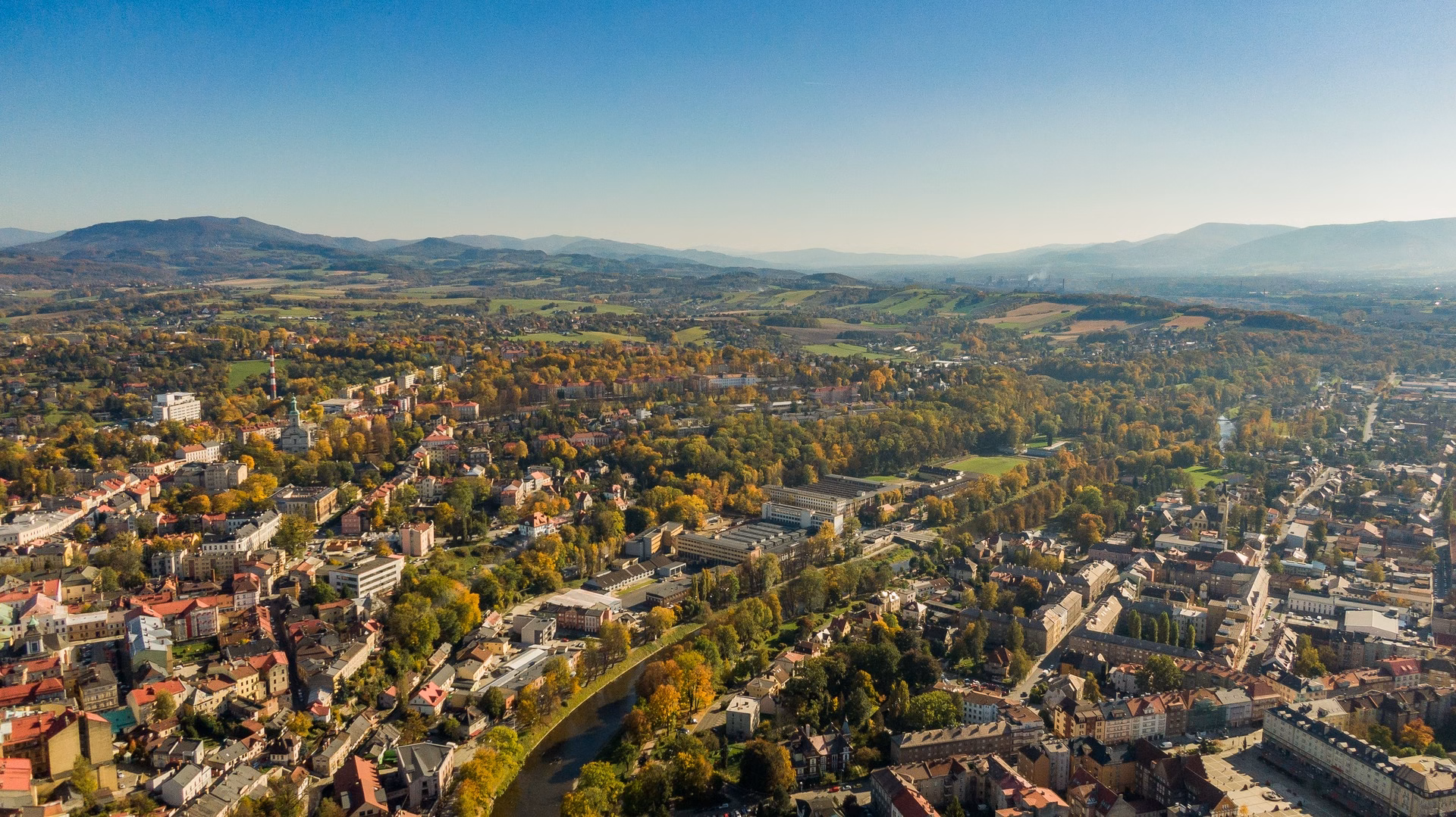 Aerial view of the twin town of Cieszyn and Český Těšín divided by the Olza river, with the Silesian Beskids in the background