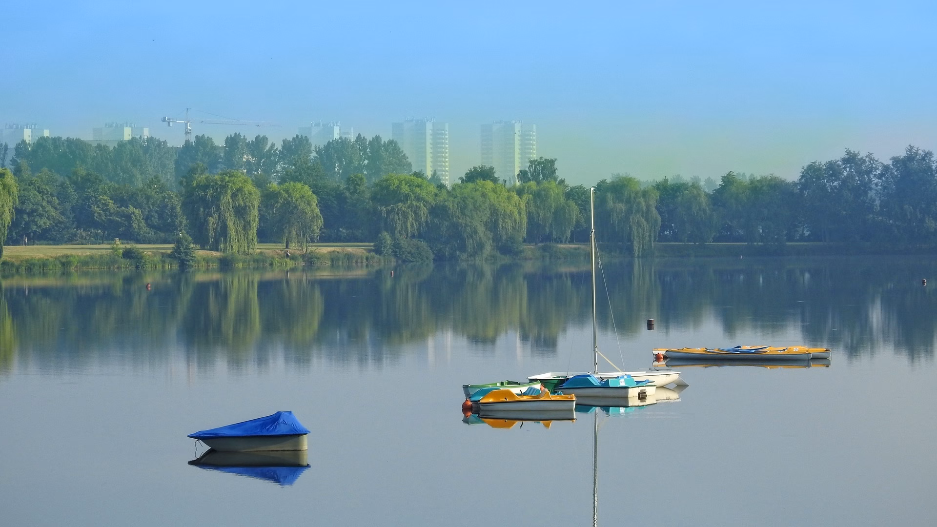 Small boats on the surface of a pond in the Three Ponds Valley, Katowice